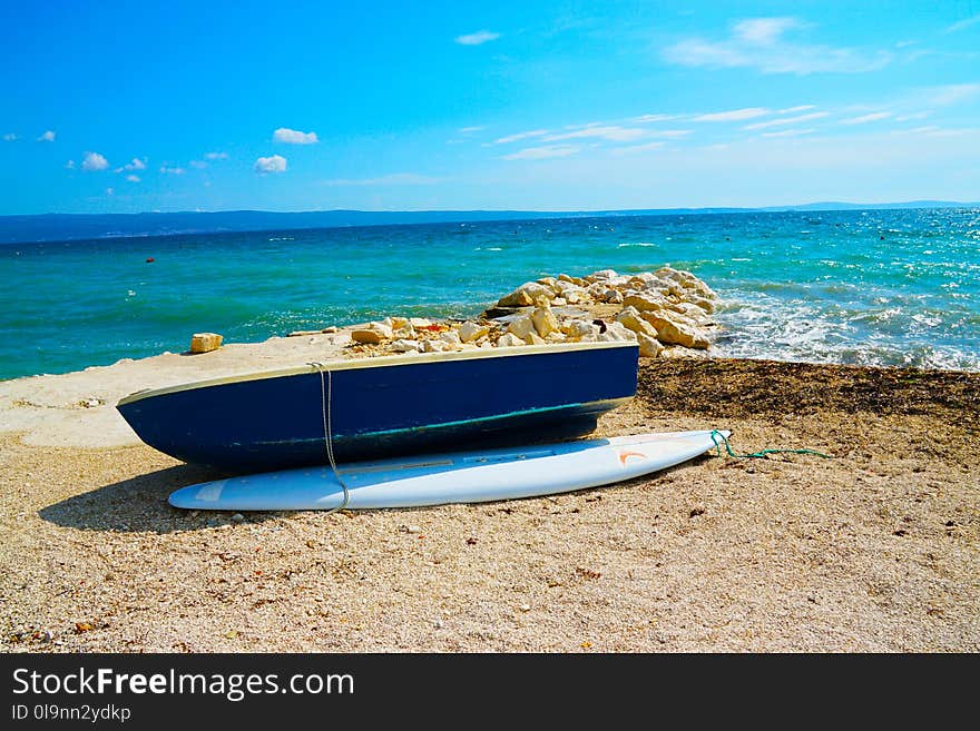 Blue Wooden Dinghy Boat Beside Body of Water