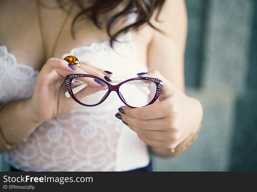 Closeup Photo of Person Holding Eyeglasses