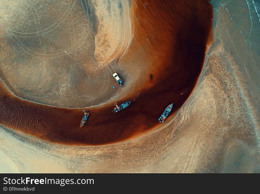 Aerial Photography of Four Blue Boats on Body of Water