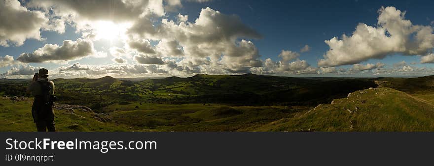 Person Standing on Green Grass Under Blue Sky Photography