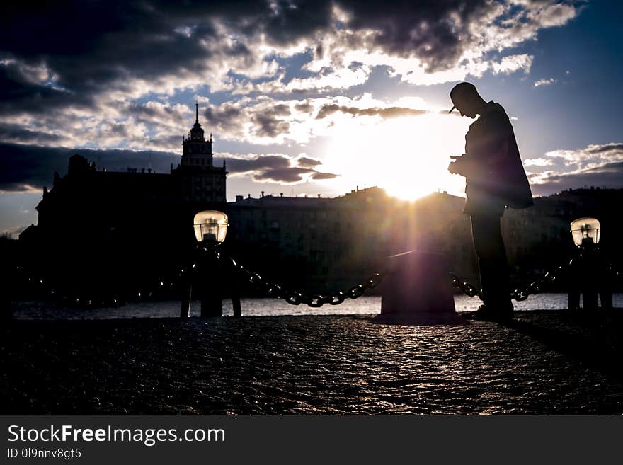 Silhouette of Man Near Body of Water