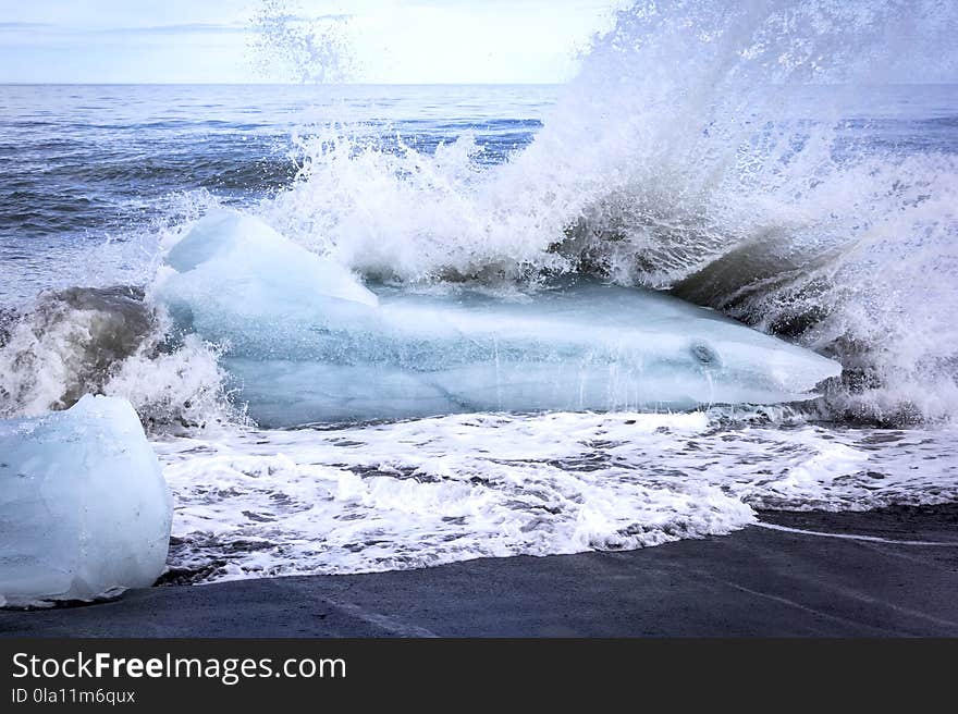 The icebergs of the Jokulsarlon lagoon in the south of Iceland form strange forms. They are partly thrown back on the beach of the Atlantic.