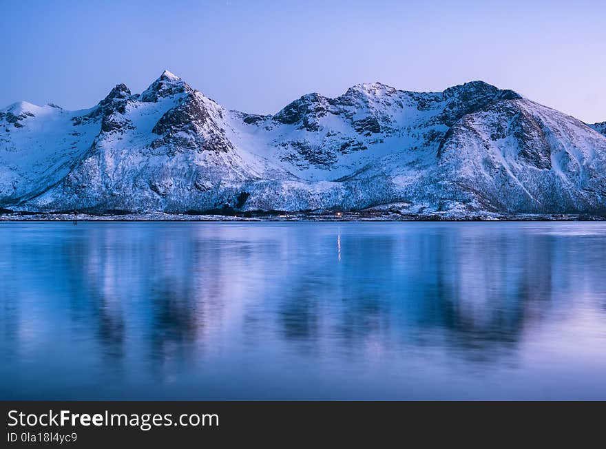 Mountain ridge and reflection in the lake. Natural landscape in the Norway