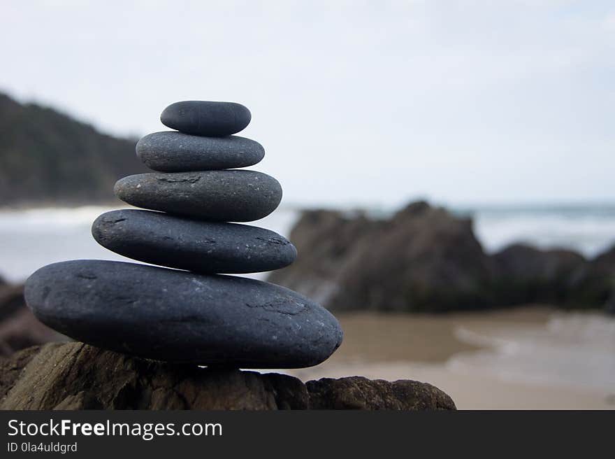 Photo of Stacked Rocks Near Shore