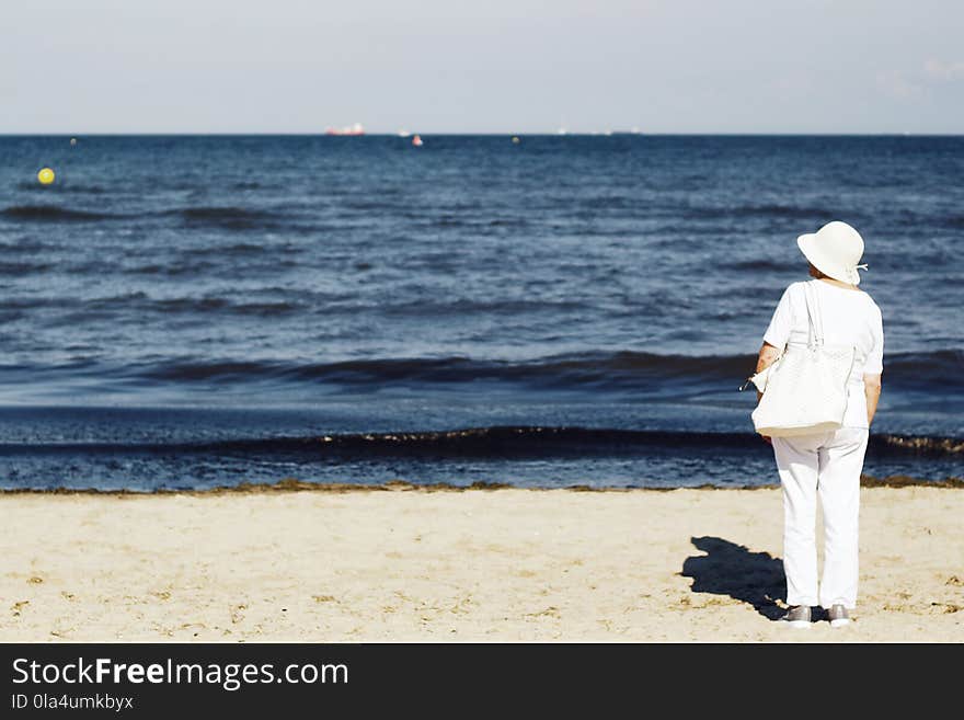 Photo of Woman Standing on Seashore