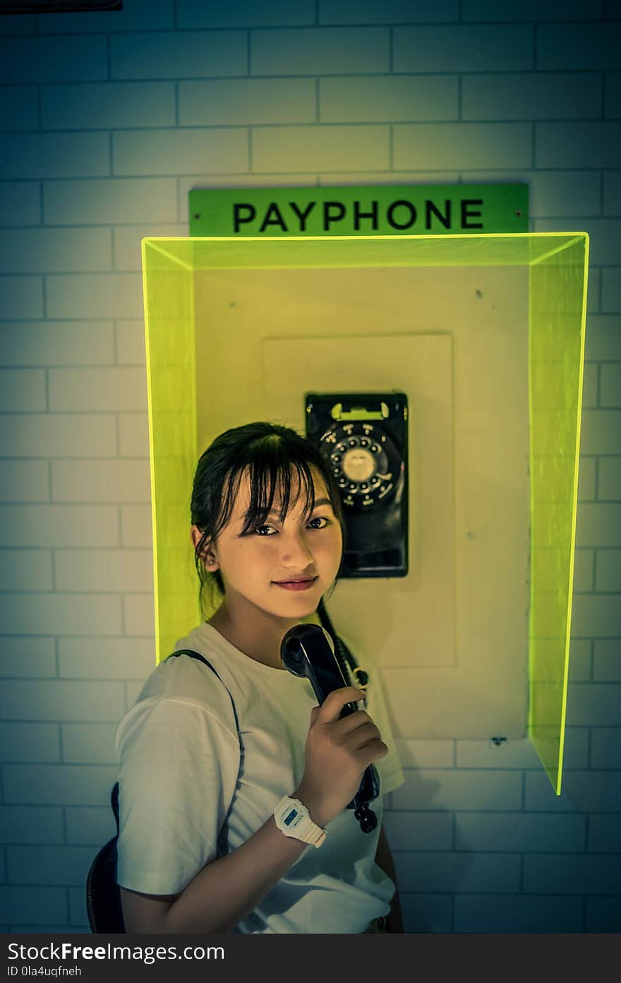 Photo of Woman Standing Beside Payphone.