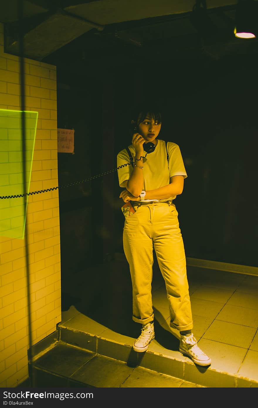 Photo of Female Standing Using a Payphone