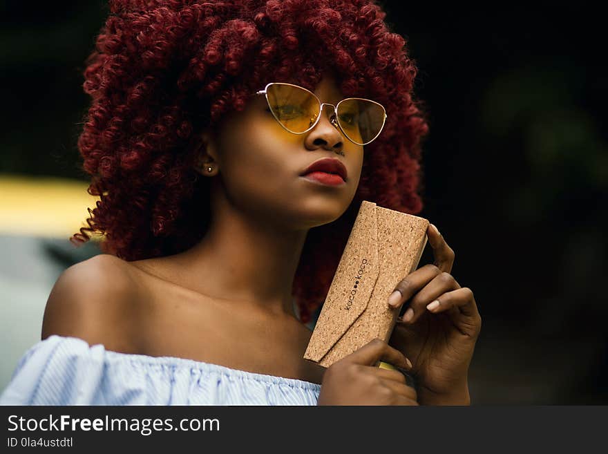 Woman Holding Brown Leather Wristlet