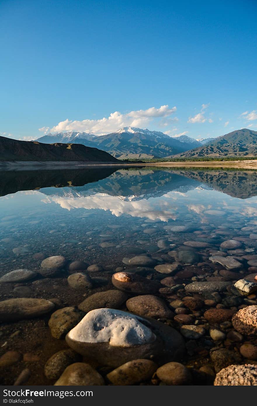 Landscape Photography of Body of Water Near Mountains