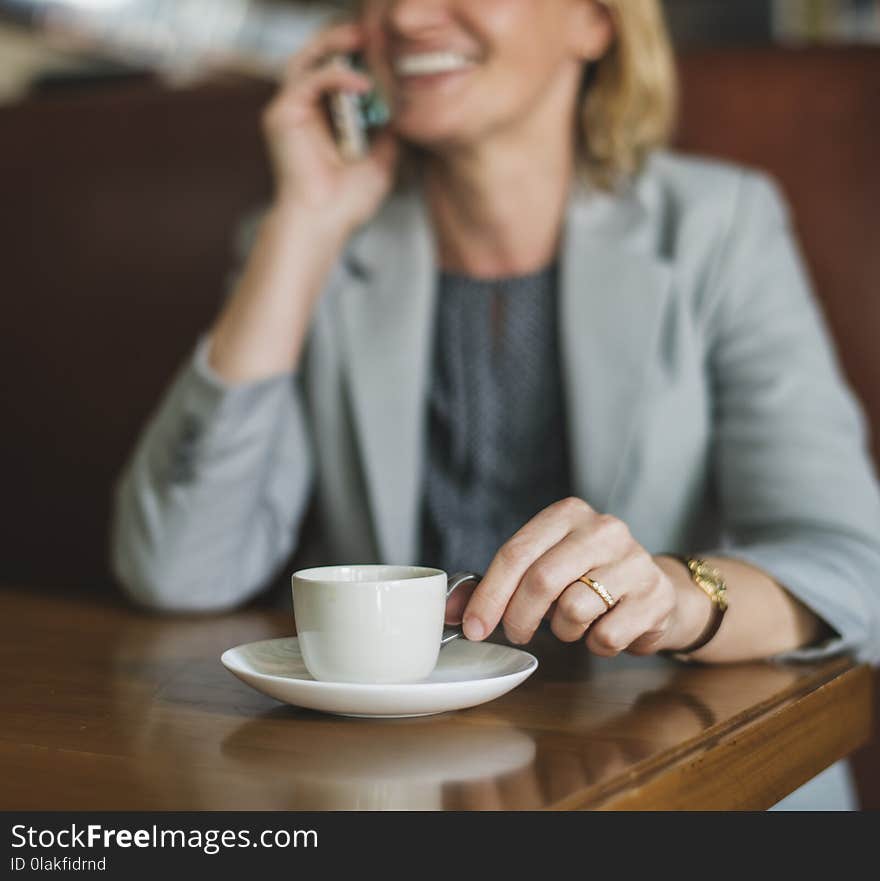 Shallow Focus Photography of Smiling Woman Holding White Cup