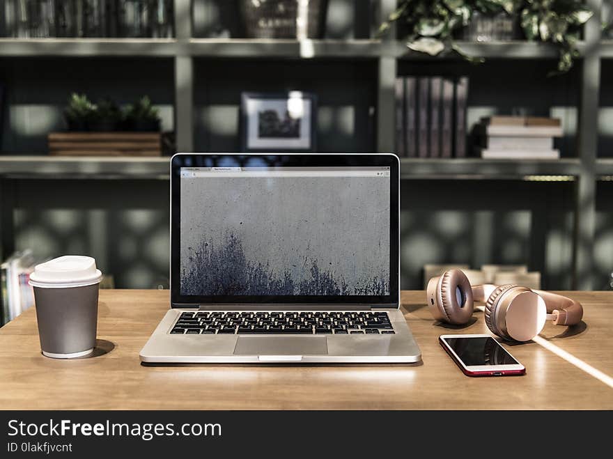 Macbook Pro on Top of Wooden Desk