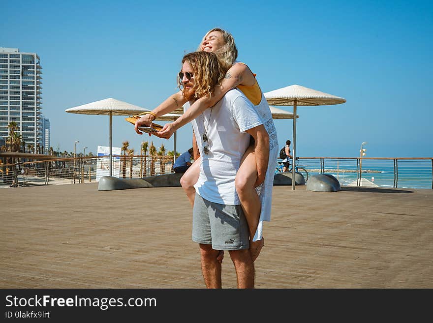 Man Wearing White Crew-neck Shirt and Grey Shorts