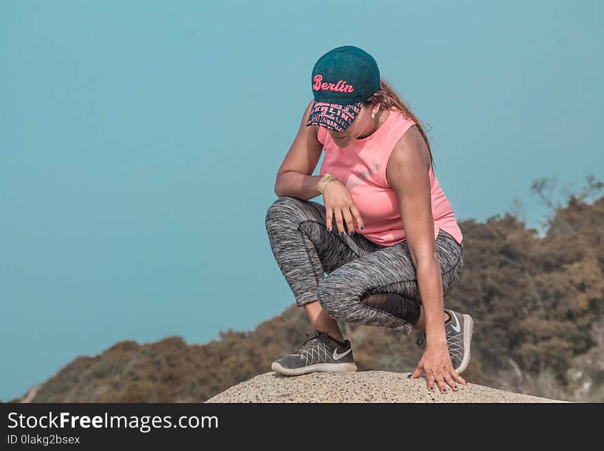 Woman Sitting on Rock