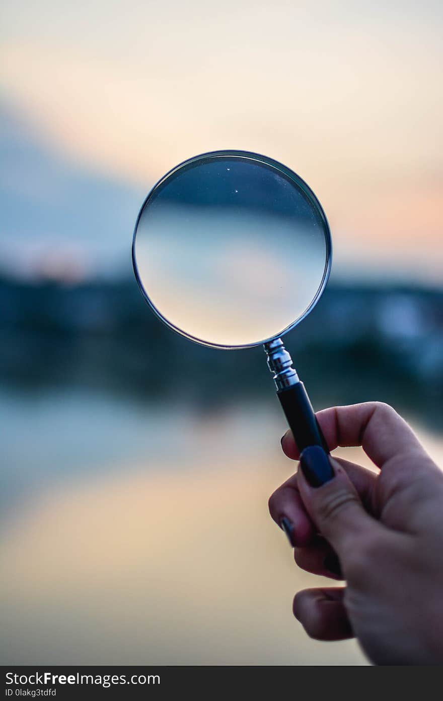 Selective Focus Photo of Magnifying Glass