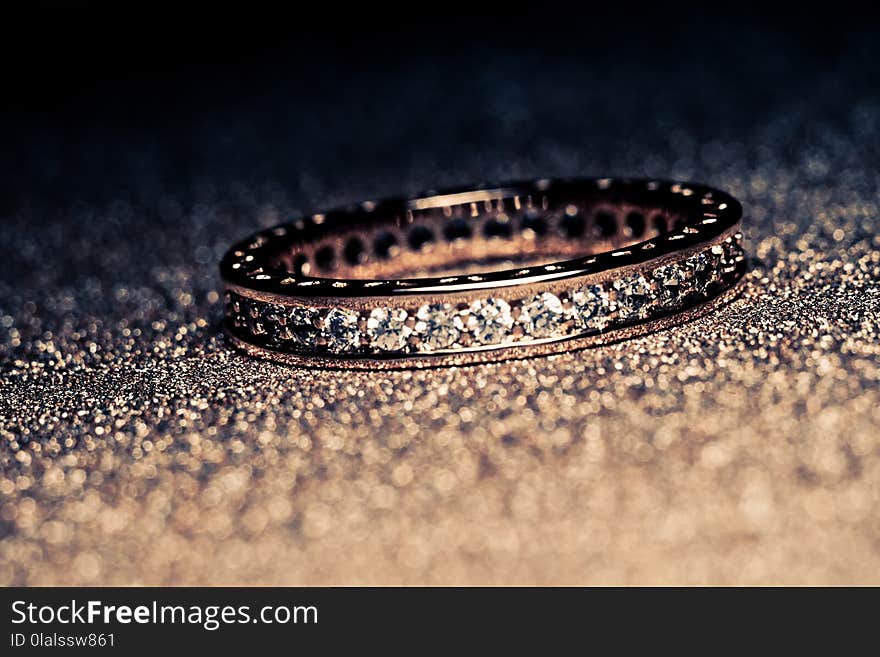 Fashion golden ring over glittering background, macro, vintage effect. Fashion golden ring over glittering background, macro, vintage effect.