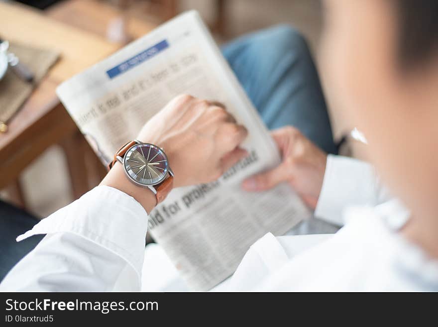 Time keeping for important appointment, a man looks on his watch of serious meeting.