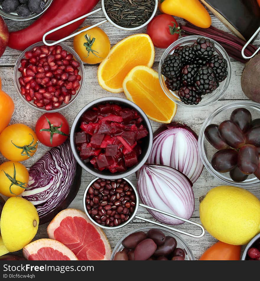 Healthy food background concept with fruit and vegetable, pulses and grain. High in antioxidants, anthocyanins and vitamins on rustic wood background. Top view. Healthy food background concept with fruit and vegetable, pulses and grain. High in antioxidants, anthocyanins and vitamins on rustic wood background. Top view.