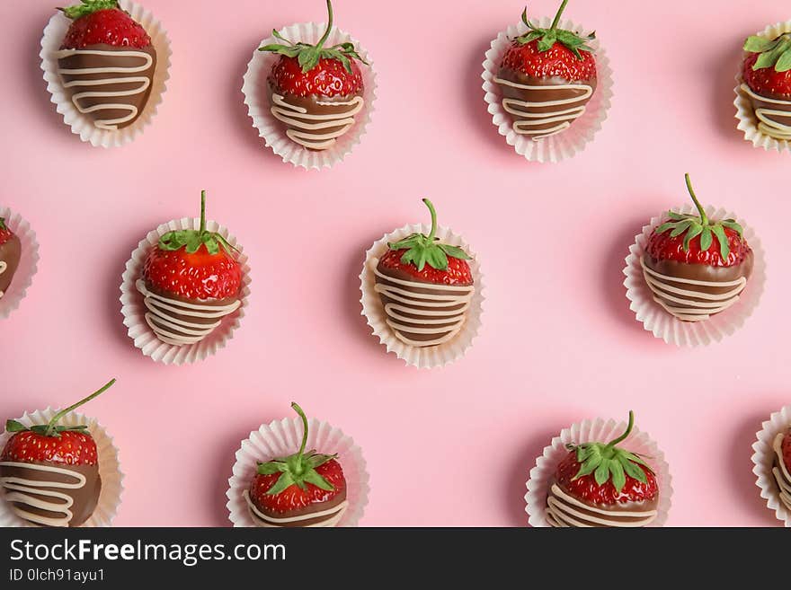 Flat lay composition with chocolate covered strawberries on color background