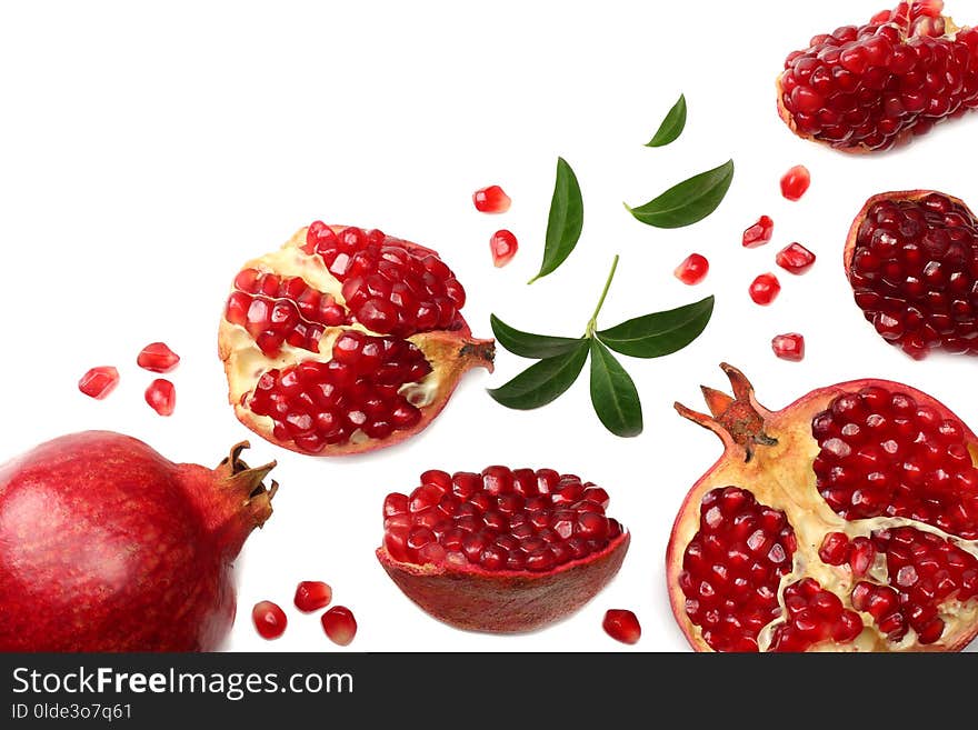 pomegranate fruit with green leaves isolated on a white background top view