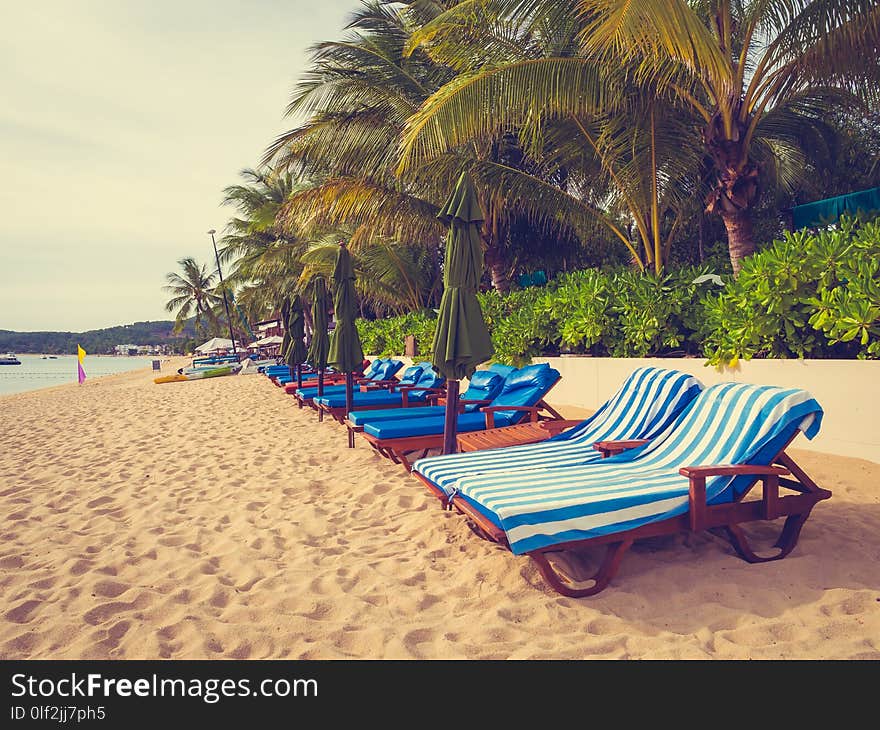 Umbrella and chair on the tropical beach sea and ocean at sunrise time