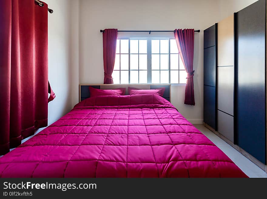 Red Pillow and Red Blanket with Red Curtain in the Bedroom with Ambience Lighting Interior.