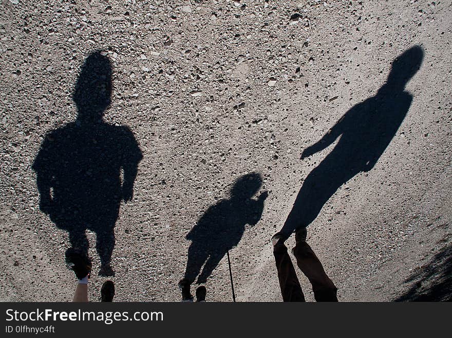 Shadows of three people walking in a mountain. Shadows of three people walking in a mountain