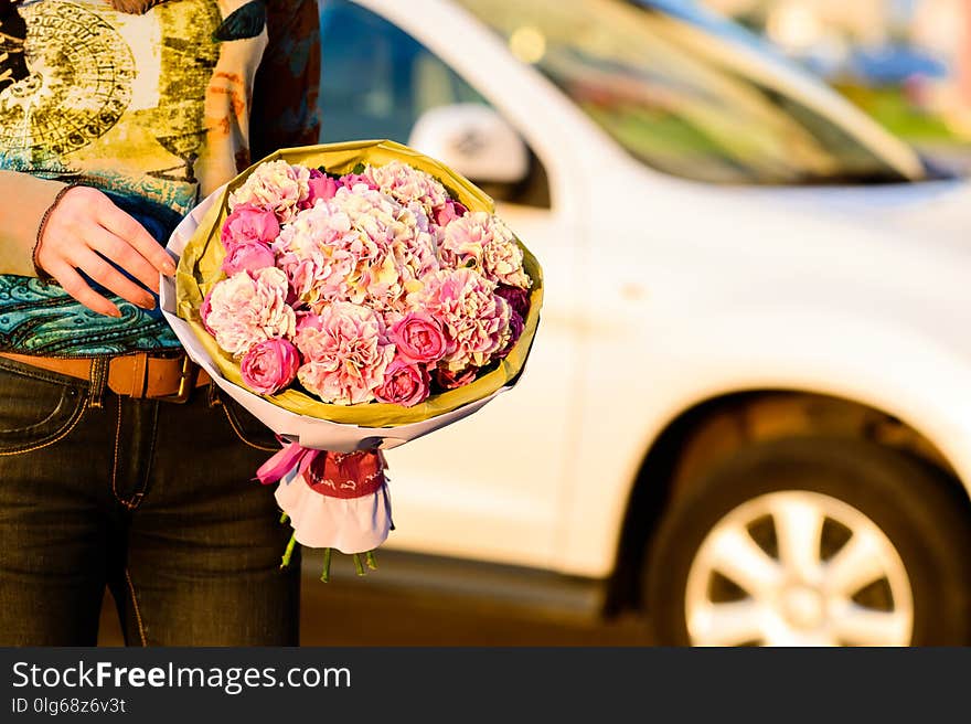 Hands of young unidentified woman holding a beautiful bouquet of