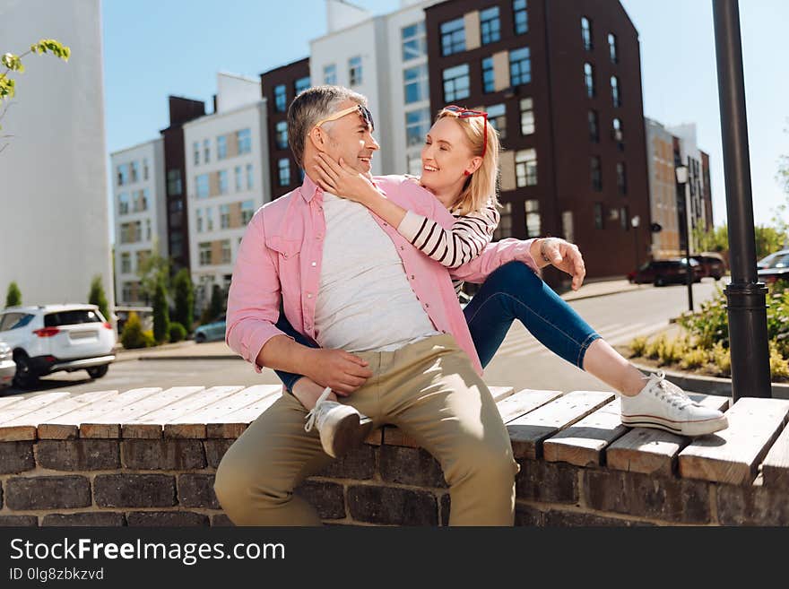 Nice Joyful Woman Holding Her Husbands Cheek