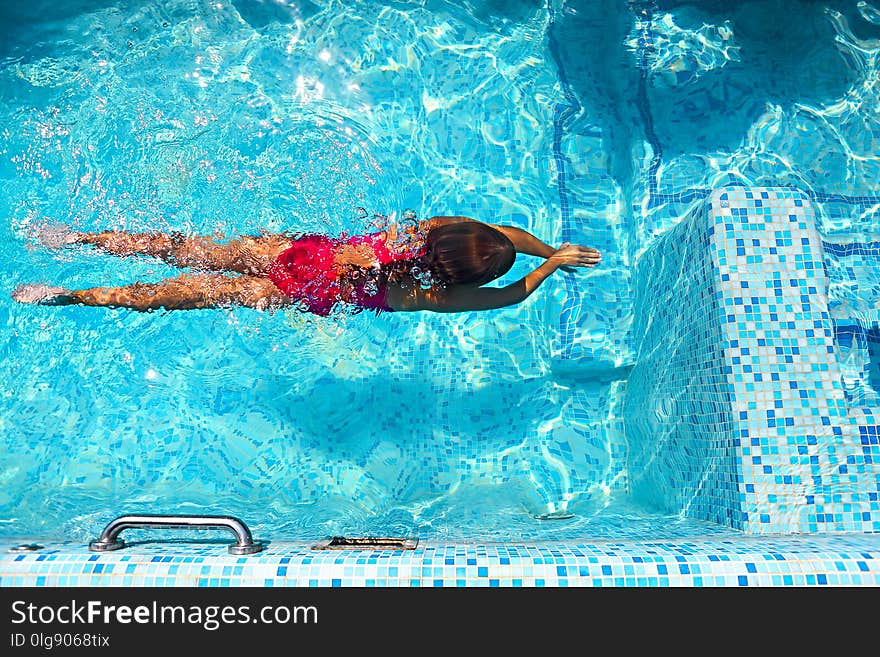 Little girl swimming in the outdoor pool. Little girl swimming in the outdoor pool