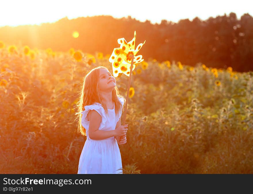 Cute little girl in summer day holds windmill in hand. Cute little girl in summer day holds windmill in hand