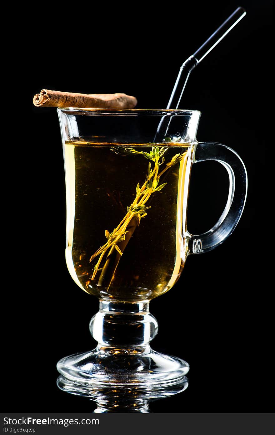 Hot Amaro cocktail with apple juice and cinnamon on dark background