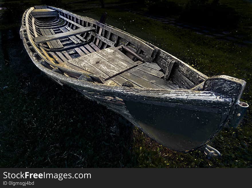 An old wooden fishing boat left on the shore. An old wooden fishing boat left on the shore