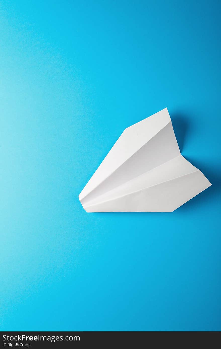 Paper airplane on blue background