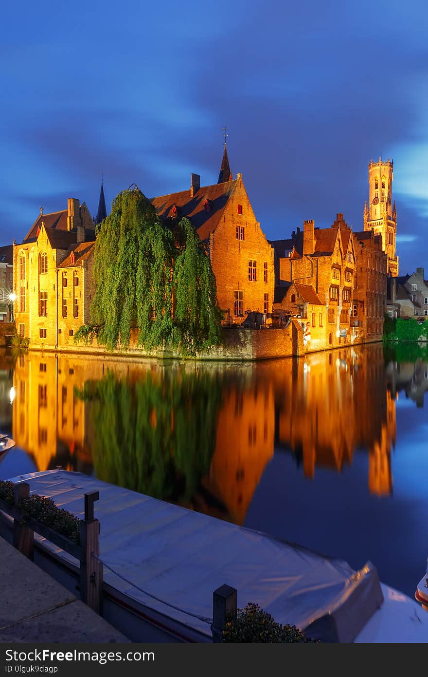 Scenic cityscape with a medieval fairytale town and tower Belfort from the quay Rosary, Rozenhoedkaai, at night in Bruges, Belgium. Scenic cityscape with a medieval fairytale town and tower Belfort from the quay Rosary, Rozenhoedkaai, at night in Bruges, Belgium