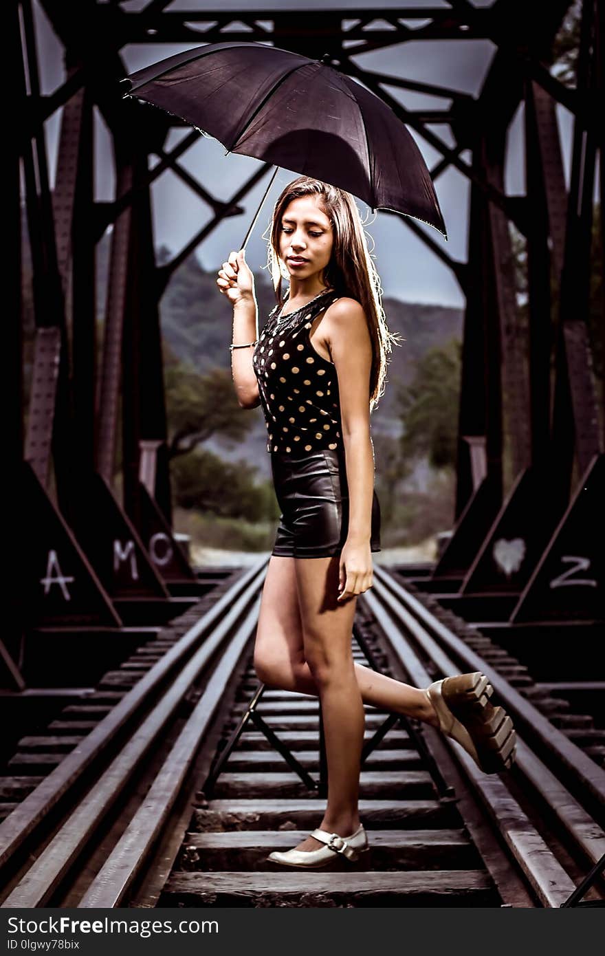 Woman posing in railroad tracks, with some women`s shoes in front focused. Woman posing in railroad tracks, with some women`s shoes in front focused