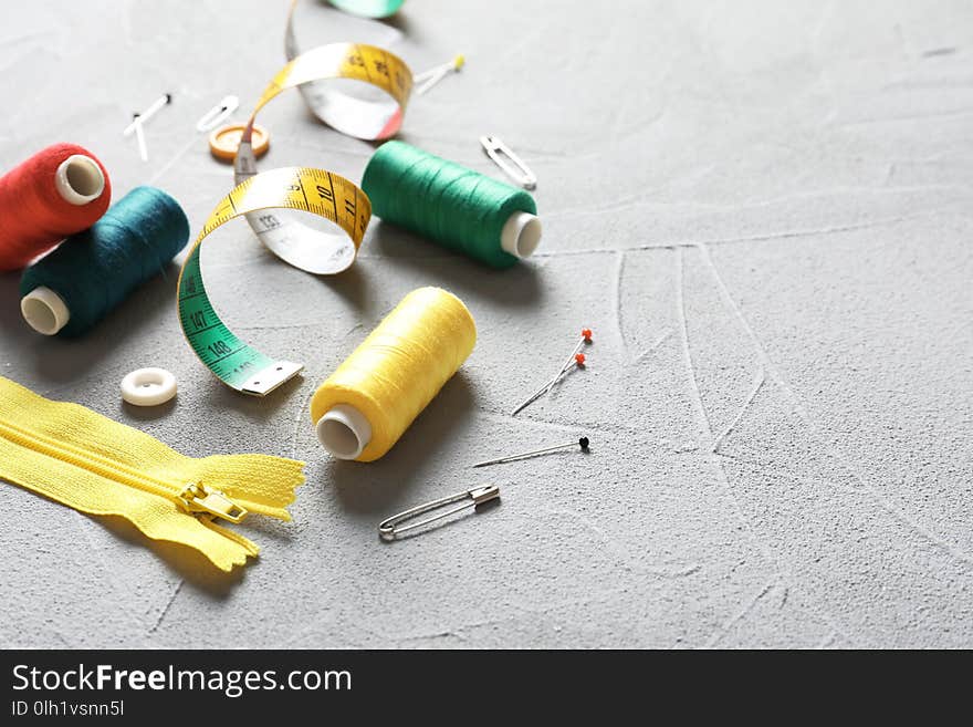 Set of tailoring accessories on grey background