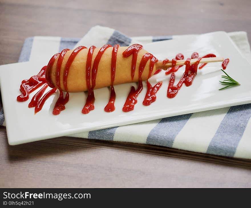 Hot Dog With Ketchup On A White Plate