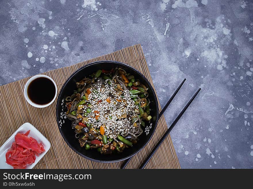 Buckwheat noodles with meat and vegetables on gray, Asian wok. Buckwheat noodles with meat and vegetables on gray, Asian wok