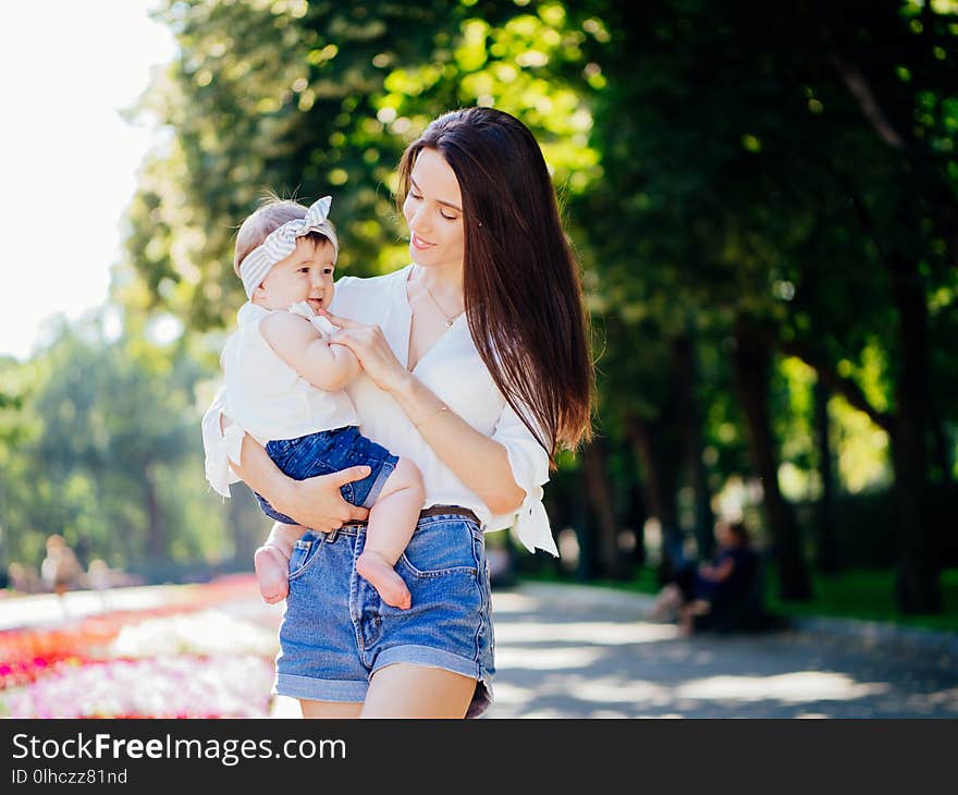 Mother with 8 month baby girl spend time in a park. Mother with 8 month baby girl spend time in a park