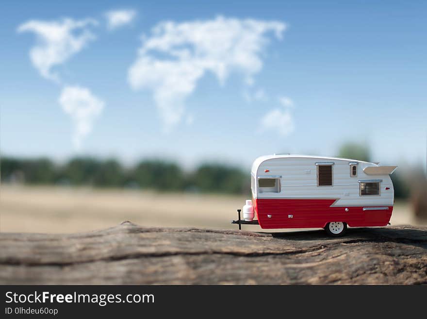 Camper van with views of the countryside and clouds in the shape of a map of the world. Camper van with views of the countryside and clouds in the shape of a map of the world