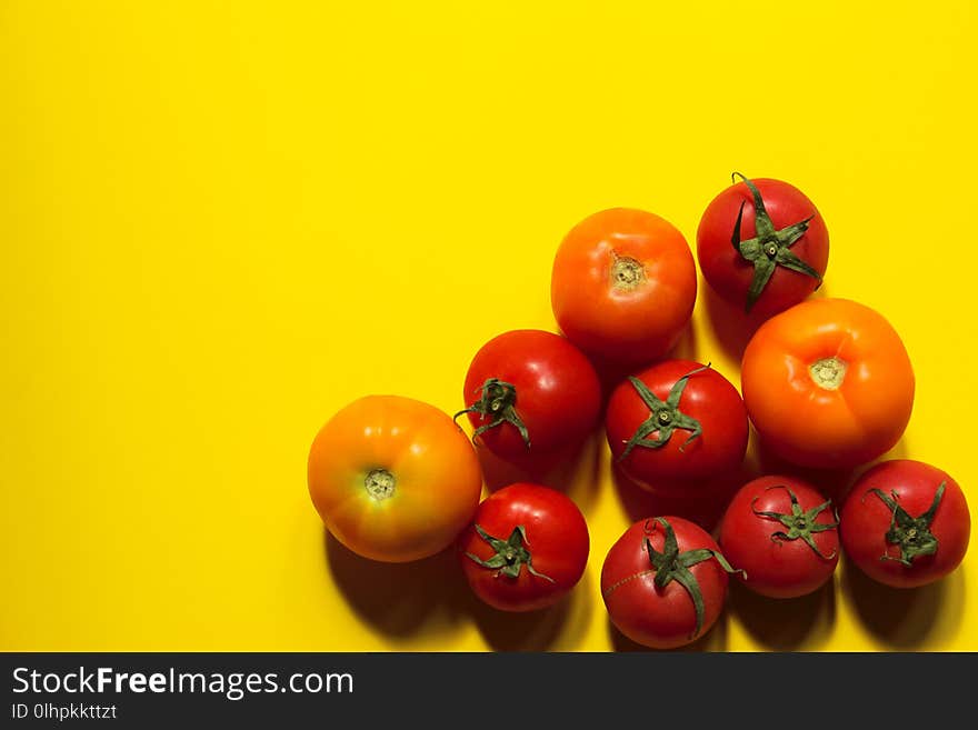 Food Concept. Tomatoes Over Yellow Background With A Lot Of Copy Space For Text. Red Tomatoes. Food Concept. Tomatoes Over Yellow Background With A Lot Of Copy Space For Text. Red Tomatoes.