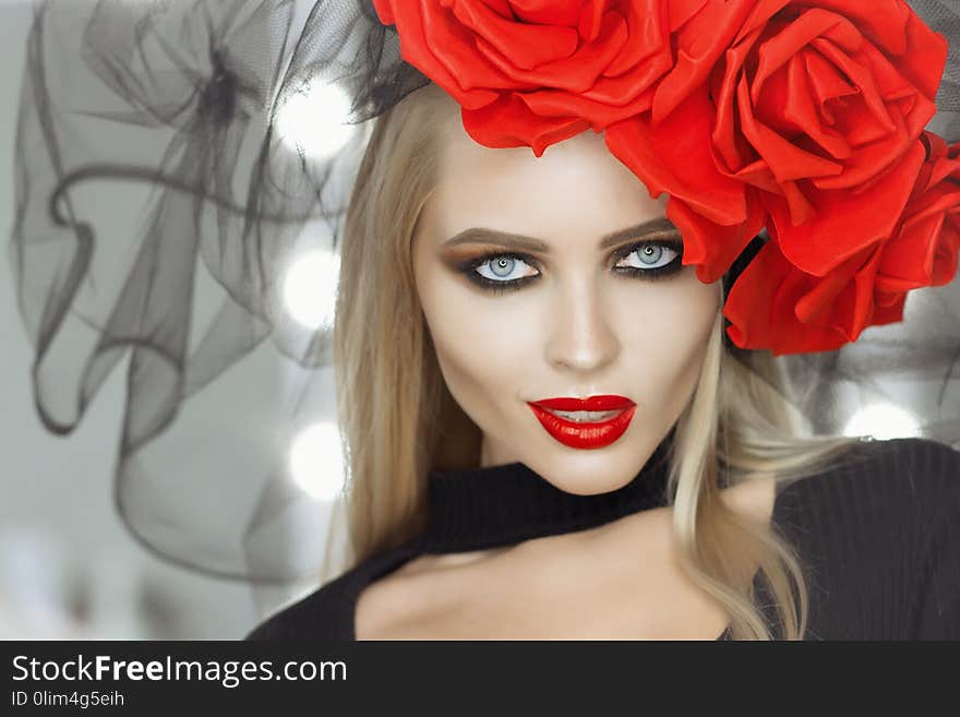 Attractive lady with bright makeup wearing Goth outfit and looking at camera while standing in studio. Attractive lady with bright makeup wearing Goth outfit and looking at camera while standing in studio