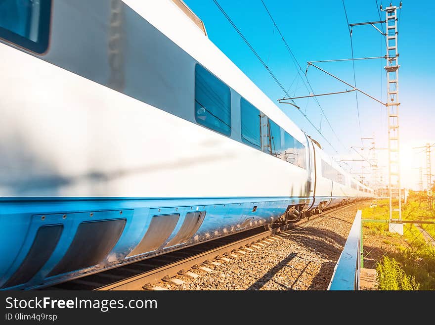 High speed electric train wagons passenger rides at the railway station in the city.