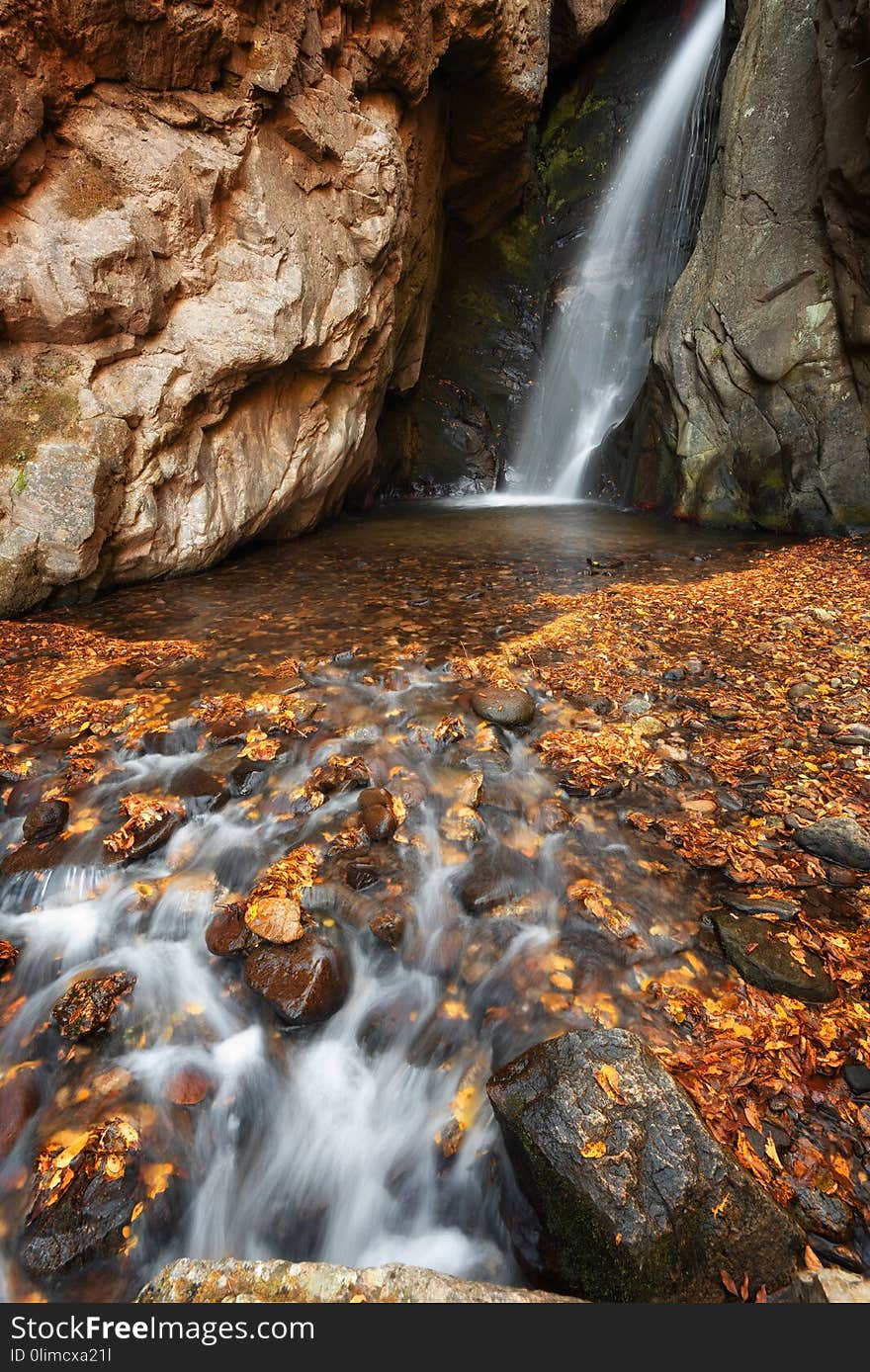 Beautiful river waterfall in autumn forest, a small waterfall part of Fotinski Waterfalls, Rhodope Mountains, Bulgaria.