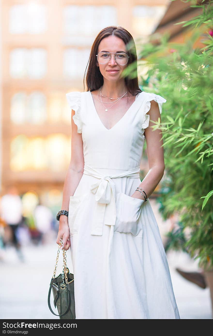 Woman walking in city. Young attractive tourist outdoors in european city