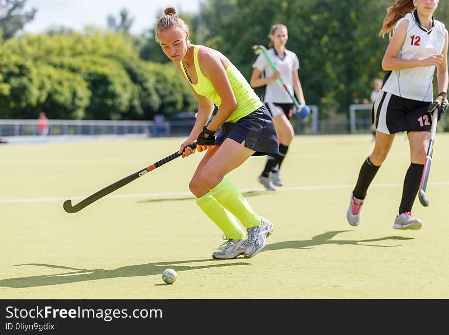 Young Hockey Player Woman With Ball In Attack