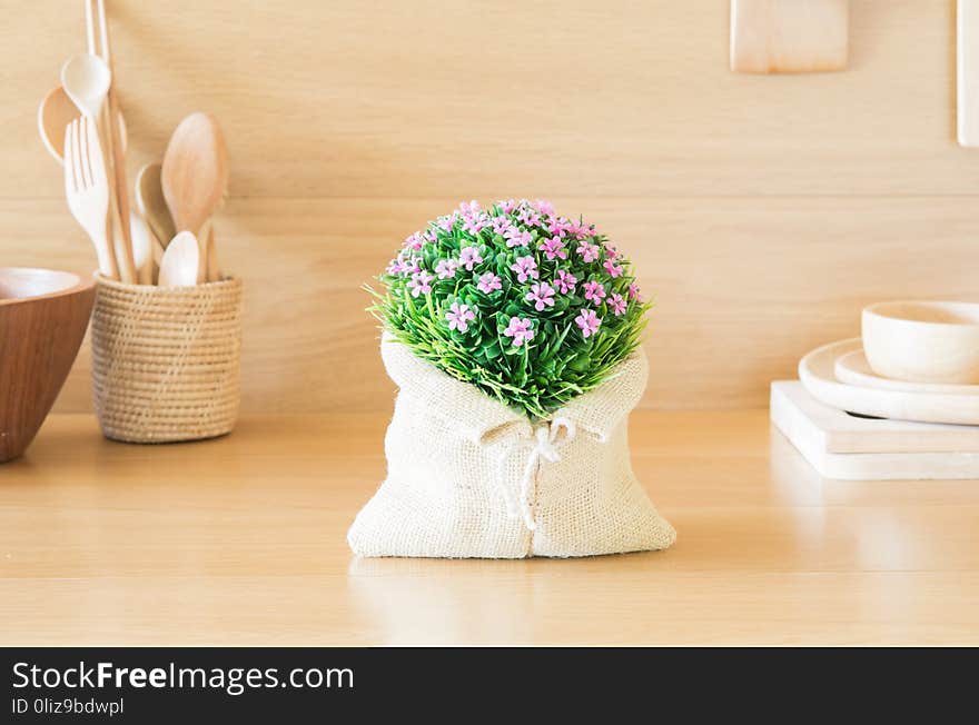 Lovely plastic flower bouquet in the wood kitchen.