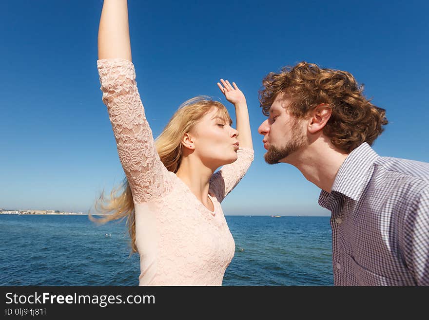 Happiness dating concept. Couple in love blonde women handsome bearded men enjoy romantic date kissing, outdoor wide angle view. Happiness dating concept. Couple in love blonde women handsome bearded men enjoy romantic date kissing, outdoor wide angle view