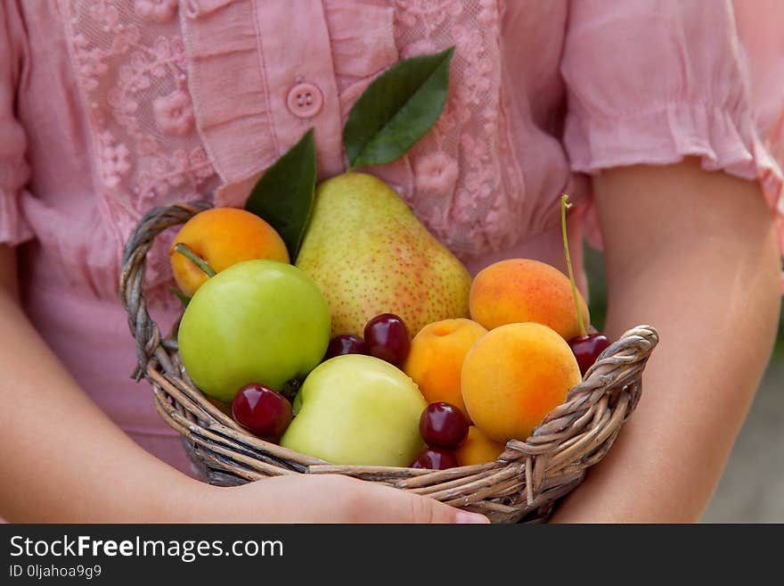 Little girl holding a basket of fruit. Little girl holding a basket of fruit