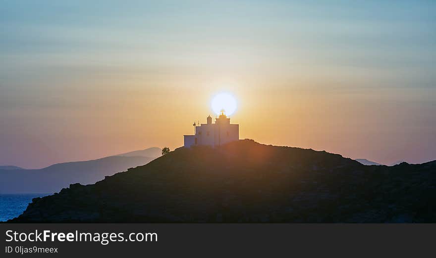 Mediterranean sea. Beautiful sunset and a lighthouse at Kea island, Greece.